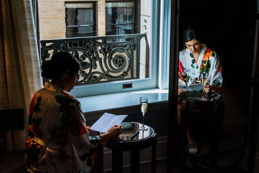 Bride writing a letter while getting ready for her Palace Hotel wedding in San Francisco