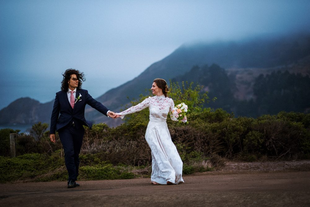 Marin wedding photography with a bride and groom walking through the coastal headlands