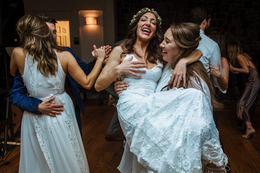 Bride laughing with friends on the dance floor at a Harvest Inn wedding in Napa Valley